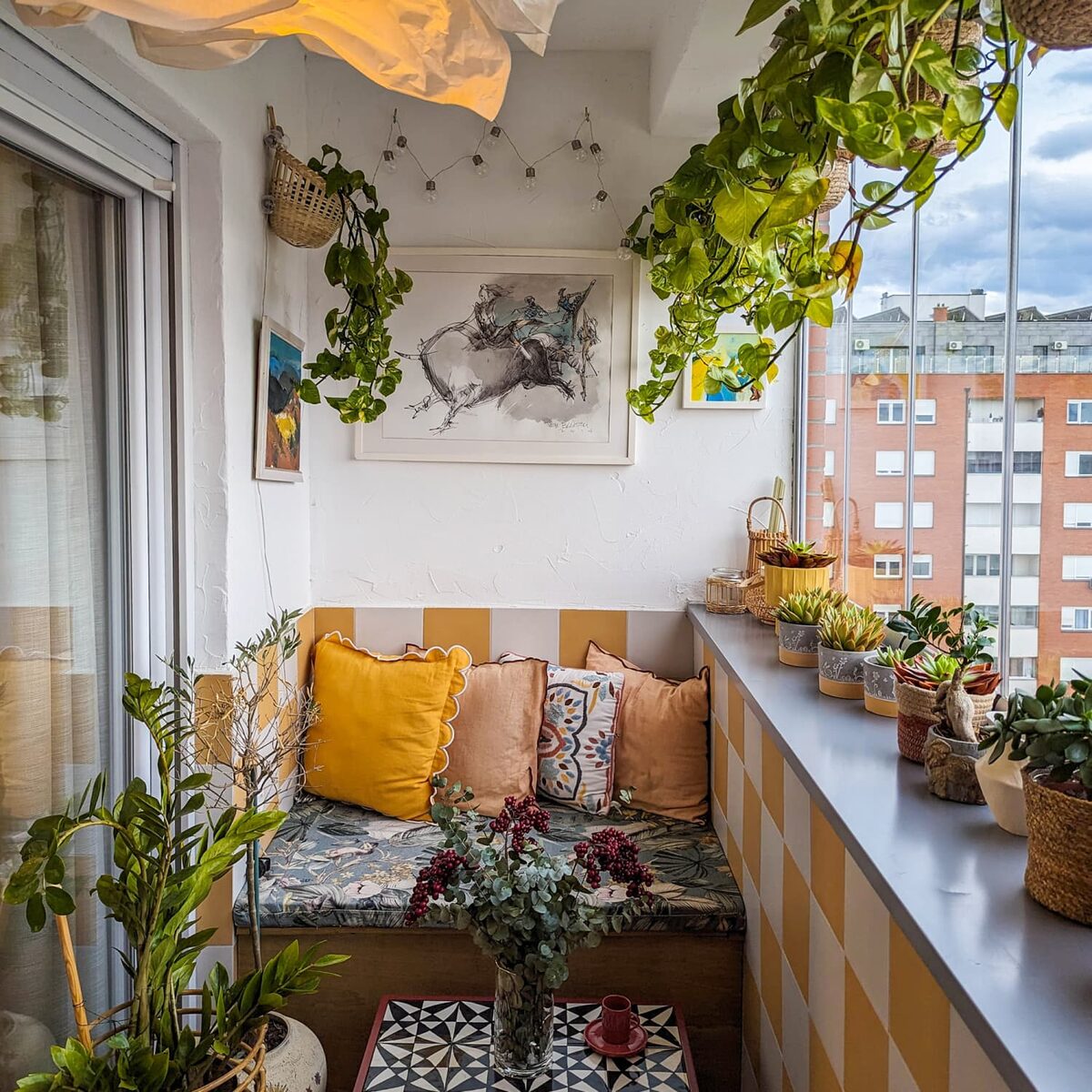 Vertical garden on small balcony with hanging plants